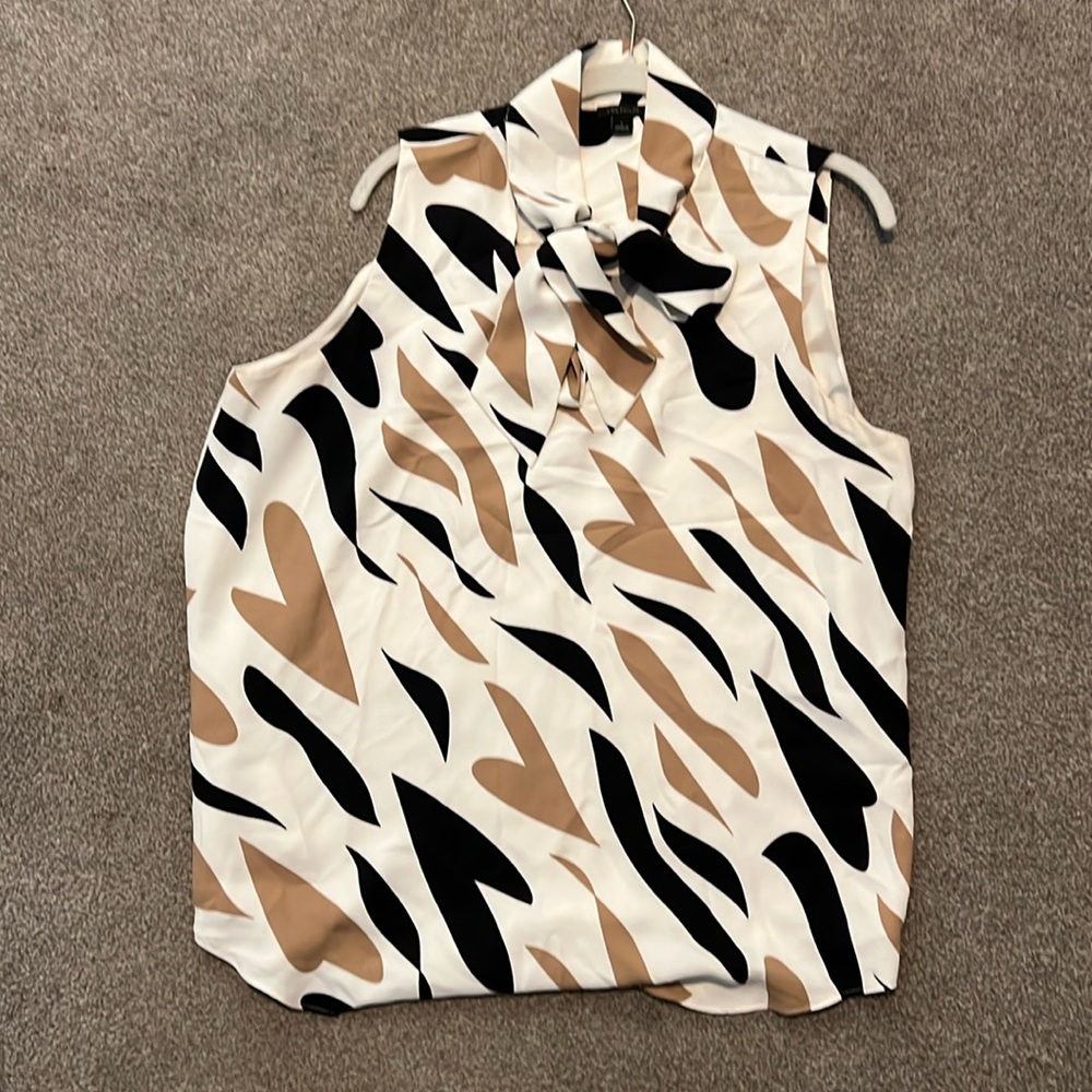 Ann Taylor sleeveless with tie neck.